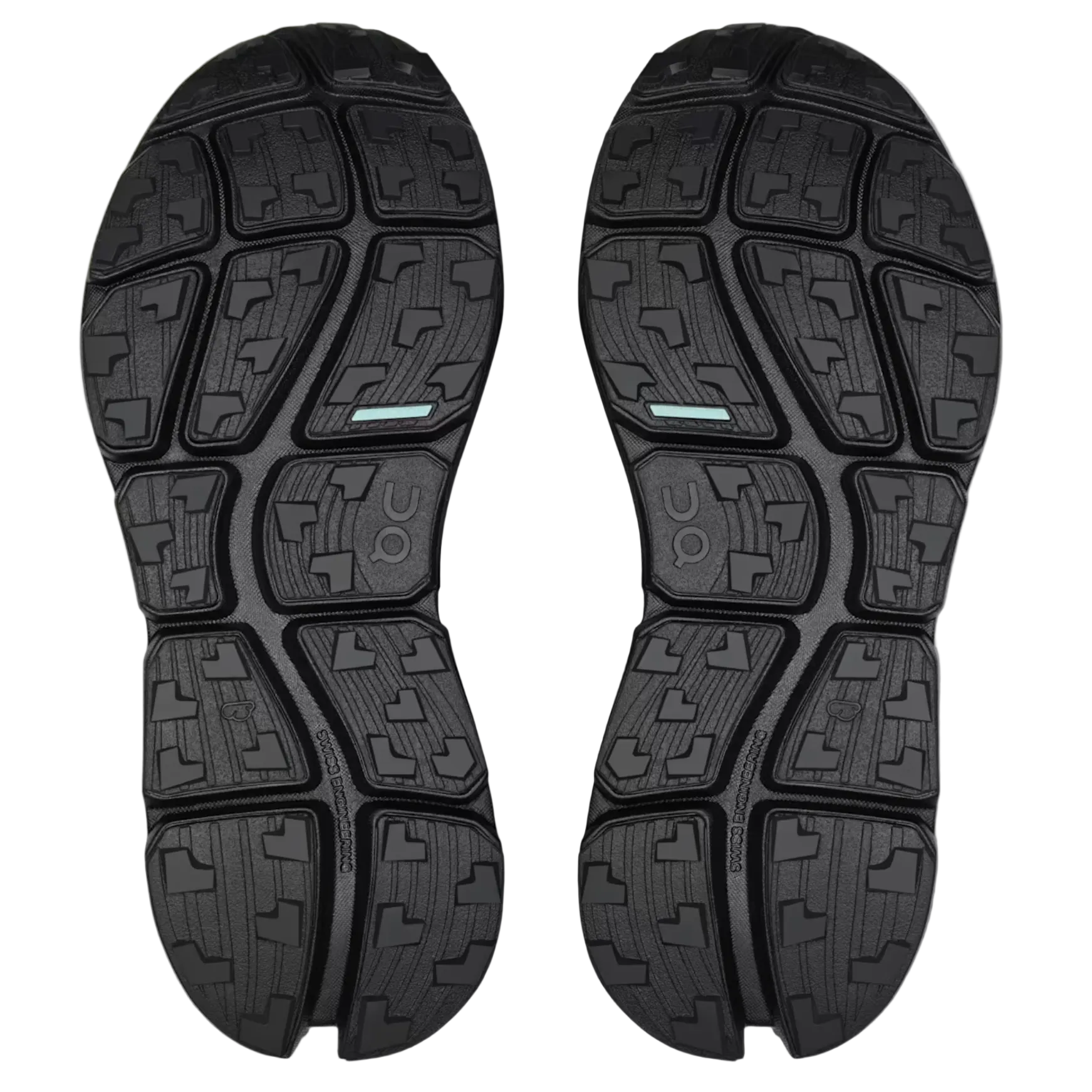 Black shoe soles with a textured pattern on a light gray background