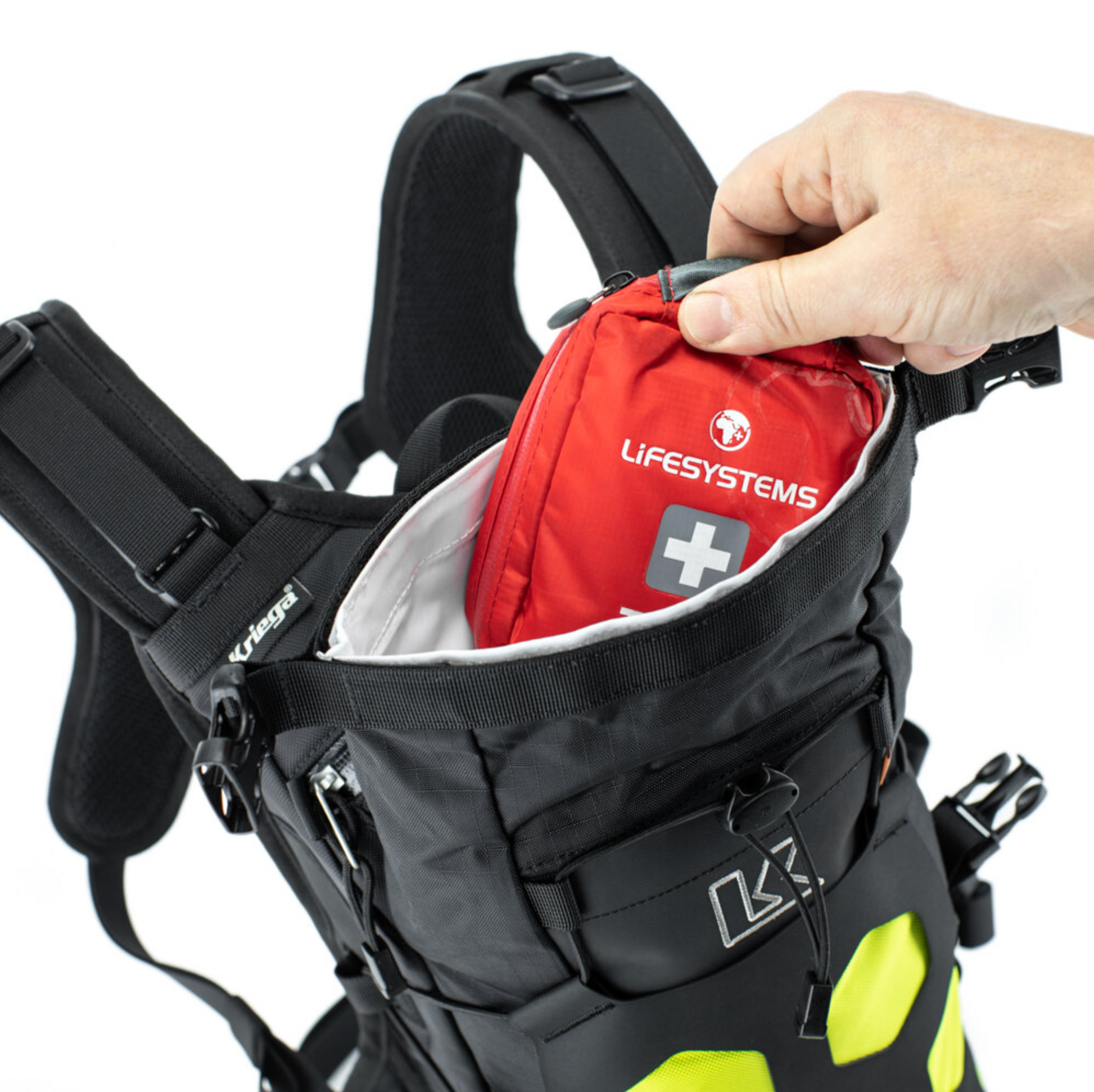 Black backpack with a red Lifesystems first aid kit being accessed by a hand on a white background