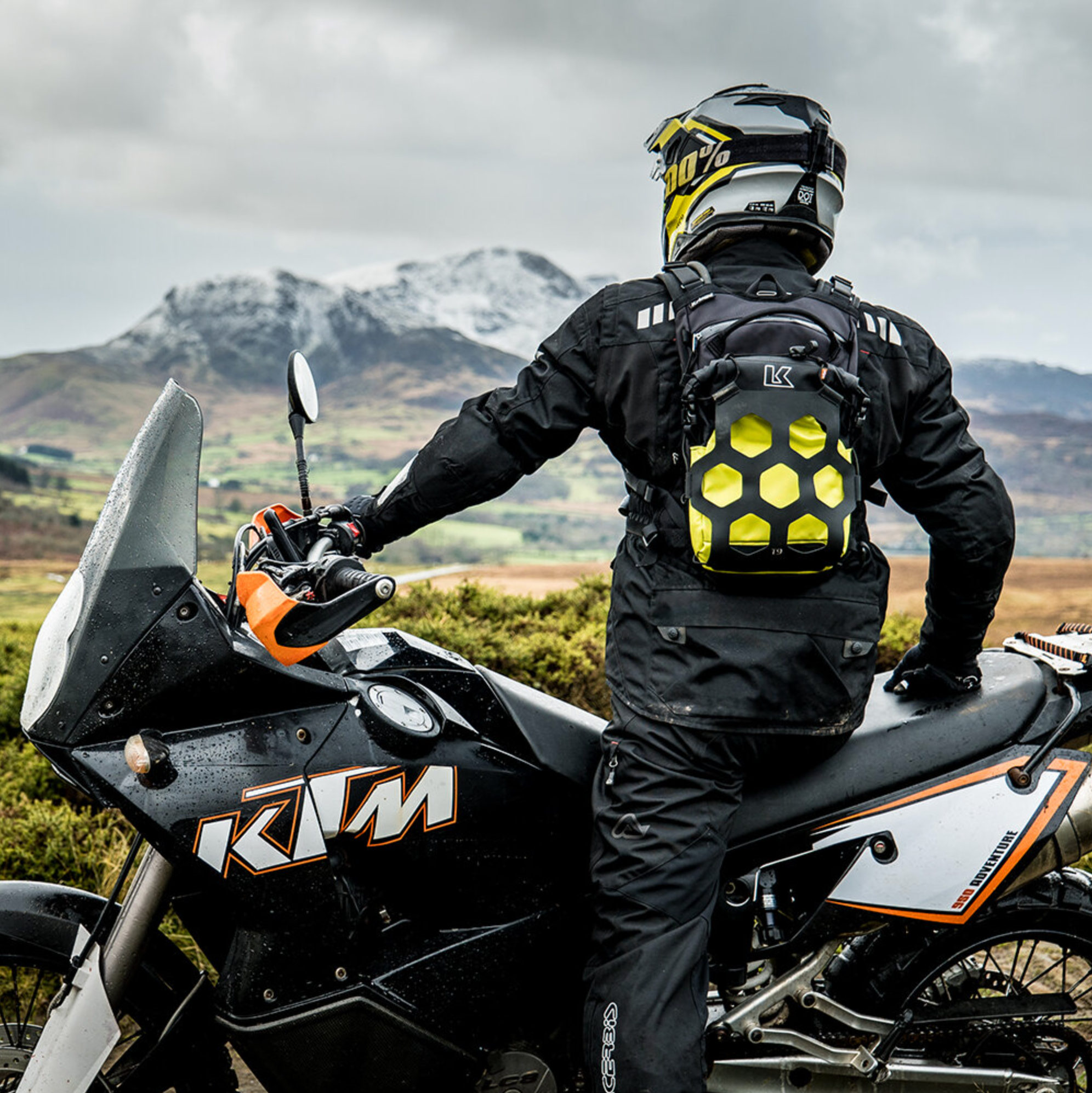 Person on a KTM motorcycle with a scenic mountain backdrop
