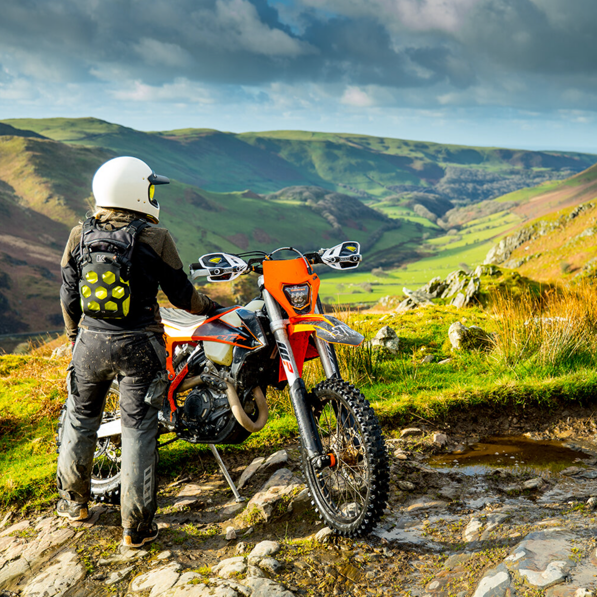 Person with a motorcycle in a scenic mountainous area