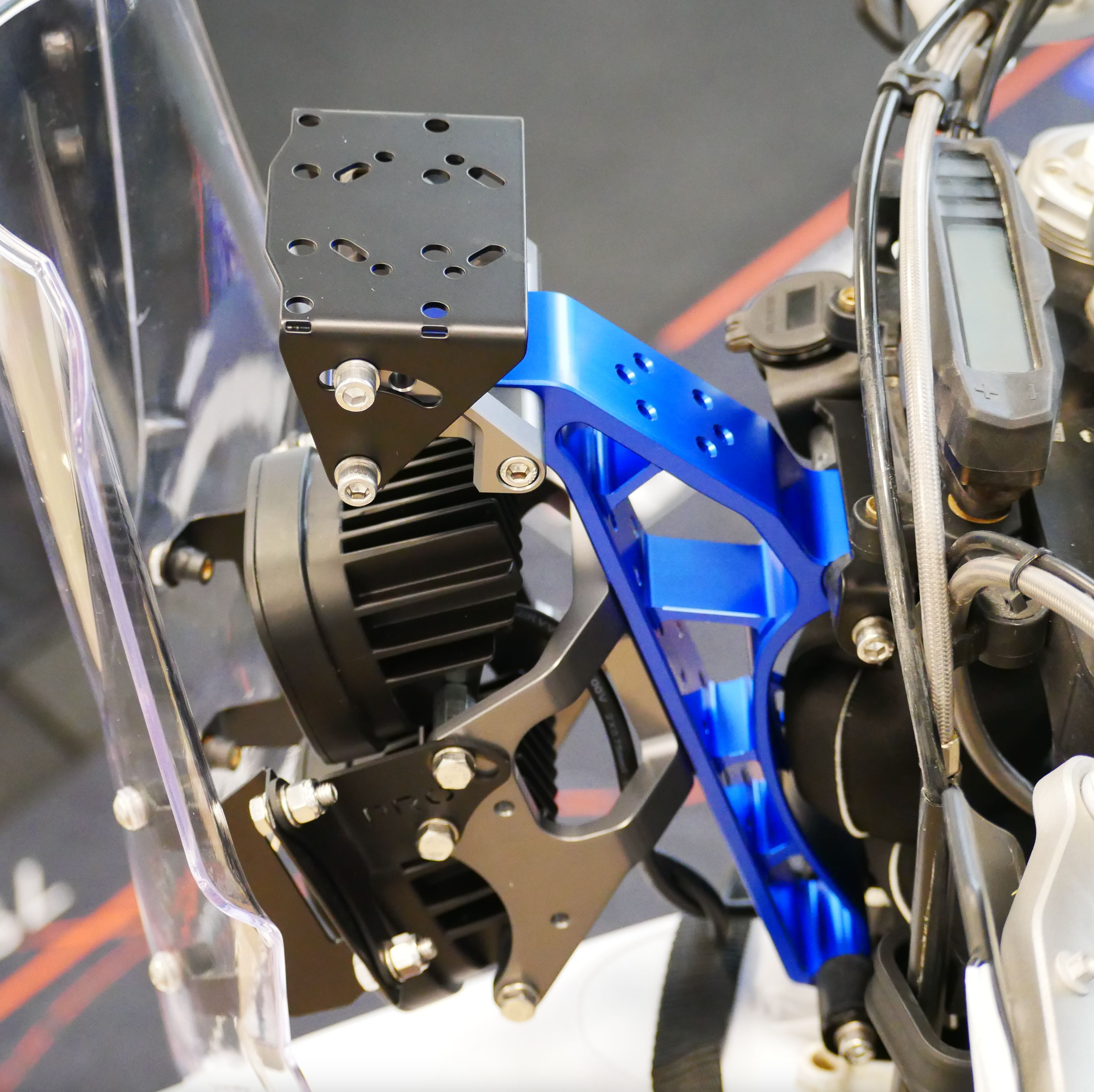 Close-up of a mechanical component with blue and black parts on a blurred background